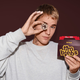 Justin Bieber holding up Tim Hortons Timbiebs